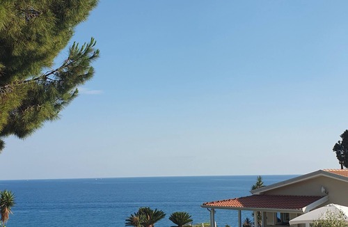 Bonifati Cottage | A beachfront cottage perched on a cliff, nestled in the lush greenery of the garden