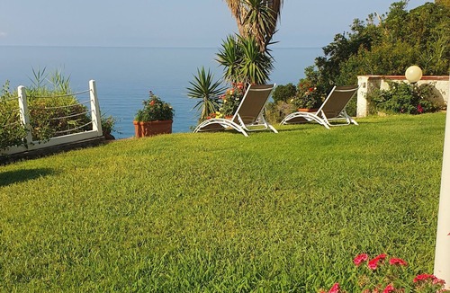 Bonifati Cottage | A beachfront cottage perched on a cliff, nestled in the lush greenery of the garden