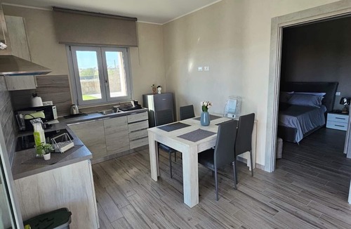 Brucoli Apartment | Cava Del Mar: comfort and relaxation in a vacation home with bedroom, living room and bathroom.