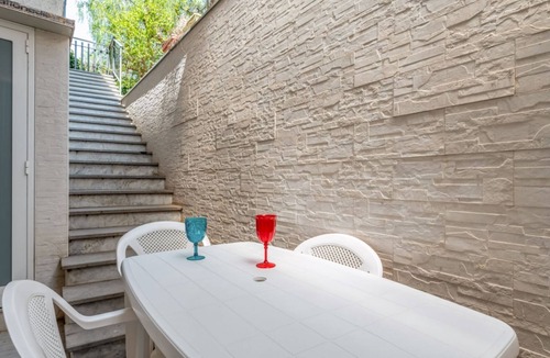 Aci Trezza Apartment | GuestHost - Spacious 120 sqm apartment in Aci Castello, ideal for 6 people. Features a balcony, private garden, and air conditioning. Aci Castello is a picturesque coastal town in Sicily, famous for its charming Norman castle by the sea. Perfect for thos