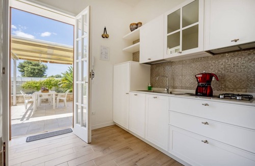 Monti D'arena-Bosco Caggione Apartment | This cozy apartment, perfect for two people, is located in a shared villa but has its own private access. It features a shared garden and a large furnished patio for exclusive use. The accommodation is located in Marina di Pulsano, a well-served seaside